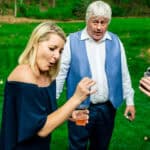 A group of people are drinking a drink in Courtney and James’ love-filled backyard during their Trempleau wedding.