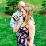 A love-filled backyard wedding featuring Courtney and James drinking wine in a field.