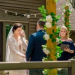 An outdoor wedding ceremony with a bride and groom: Courtney and James' Love-Filled Backyard Trempleau Wedding
