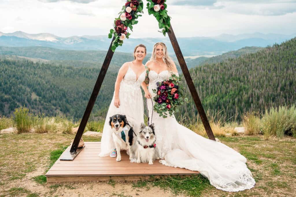 gay couple gets married granby ranch017 Two brides and their dogs at a mountain wedding.