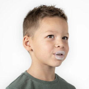 Young boy wearing a mouthguard for dental protection, close-up portrait.