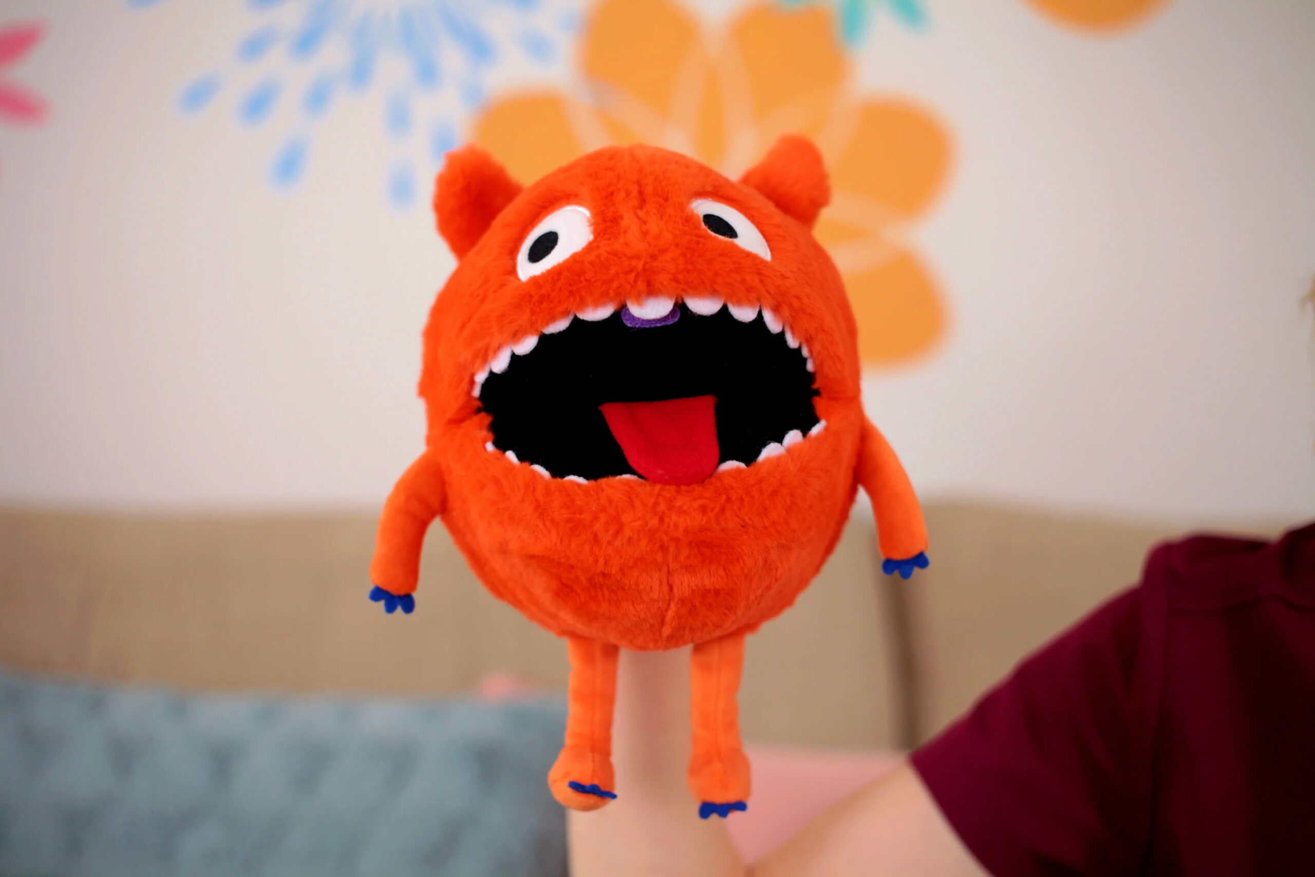 A Speech Monster with mouth open showing moveable tongue and purple placement cue behind the top teeth