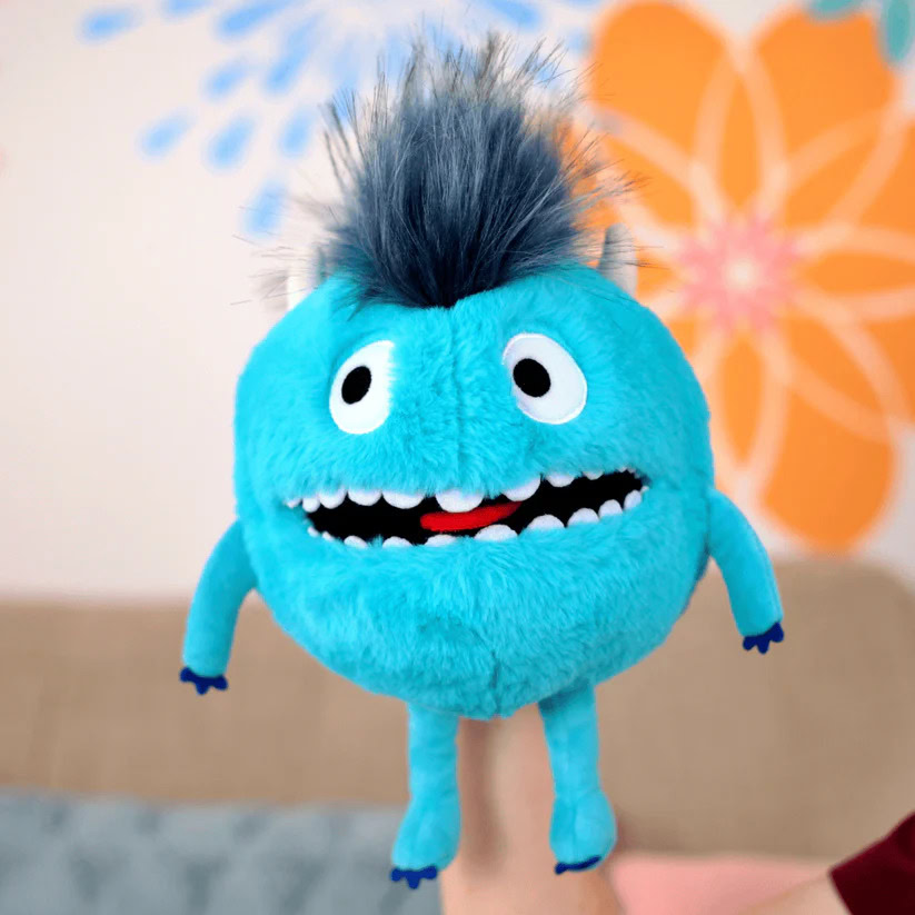 Mascot plush toy representing Breathe First with bright blue fur and cheerful face.