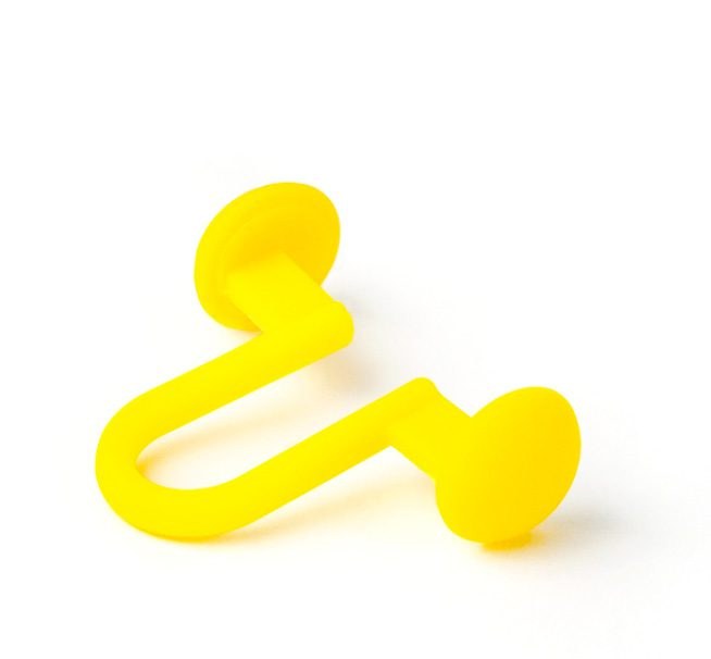 Close up of a single yellow internal nasal dilator showing the bridge and paddles
