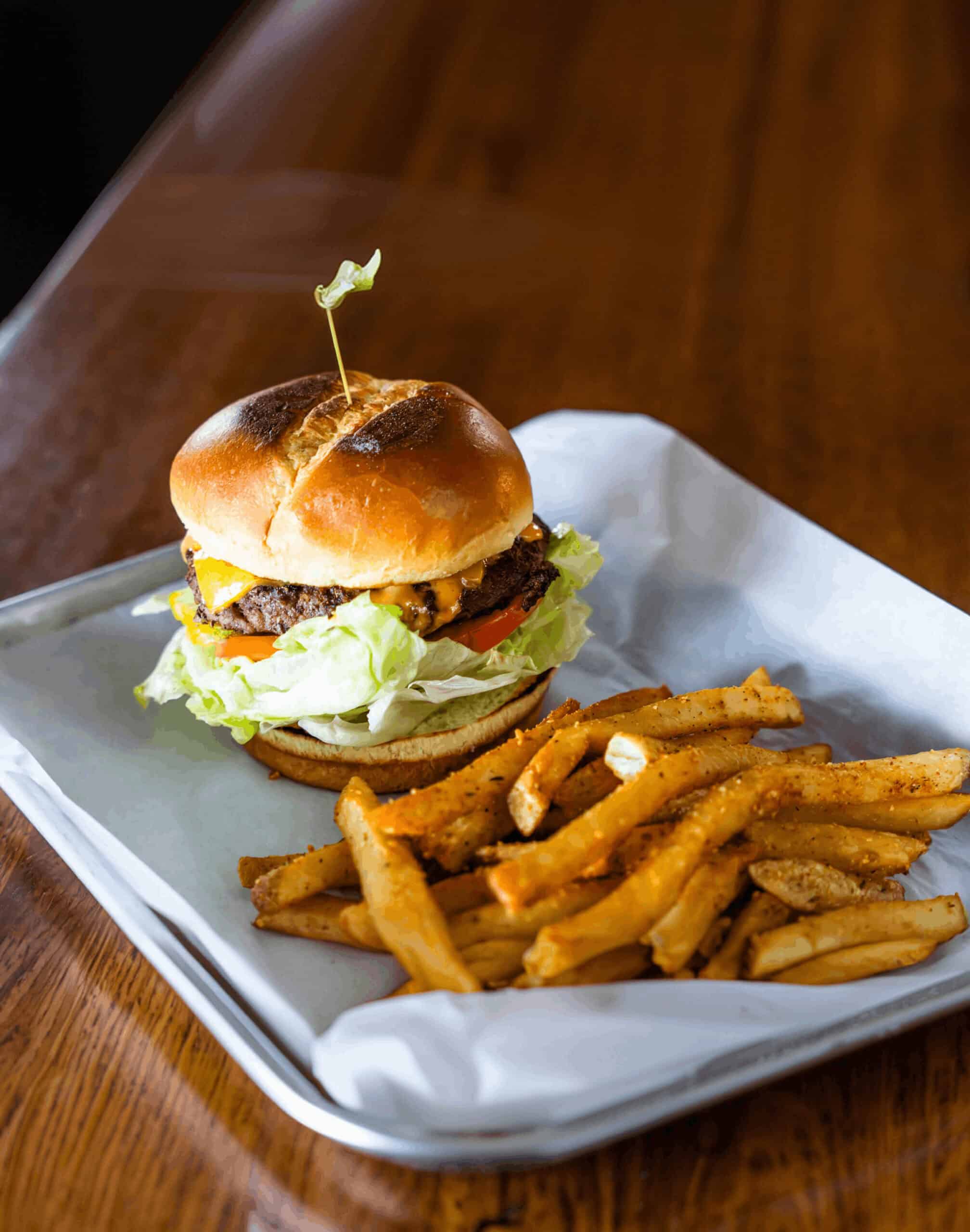Delicious cheeseburger with fresh lettuce, tomato, and melted cheese served with crispy fries.