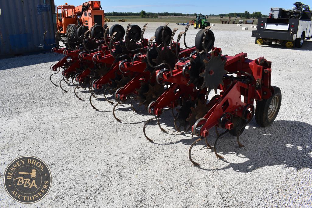 Red agricultural machinery for farming and land preparation.
