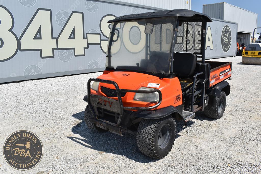 Orange golf cart with black roof at Bussey Bros Auctioneers, ideal for golf courses or transportatio.