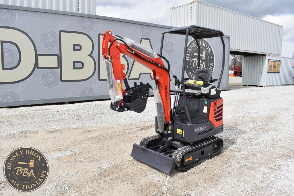Compact mini excavator with orange arm and black body at Bussey Bros Auctioneers.