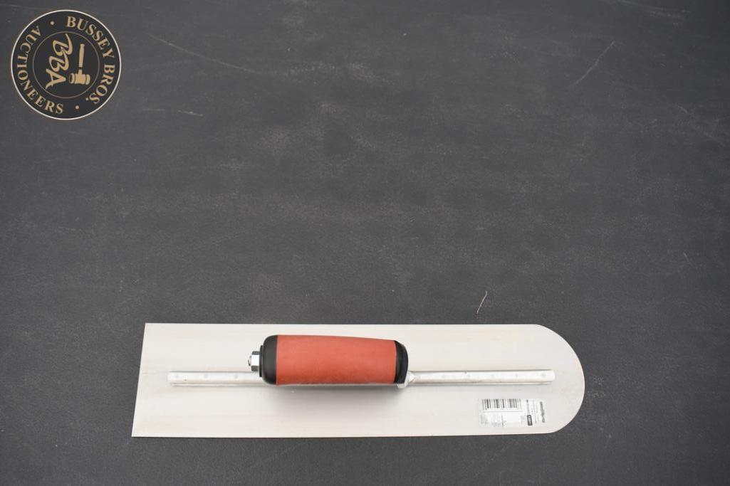 Handheld tile level with orange bubble vial for precise leveling.