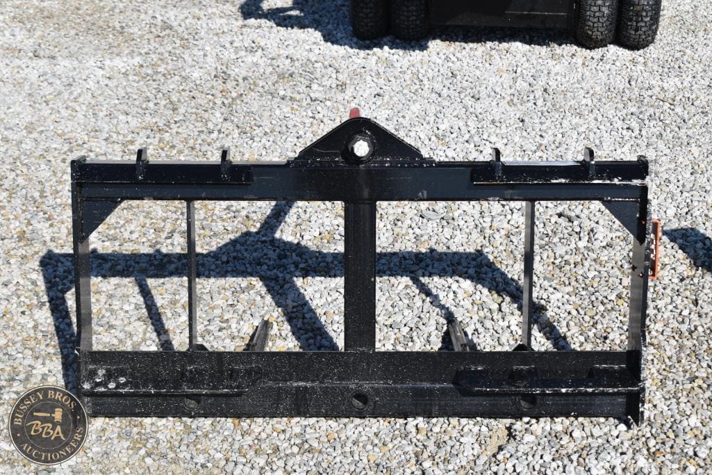 Farm equipment attachment for agricultural use, black metal implement with multiple tines.