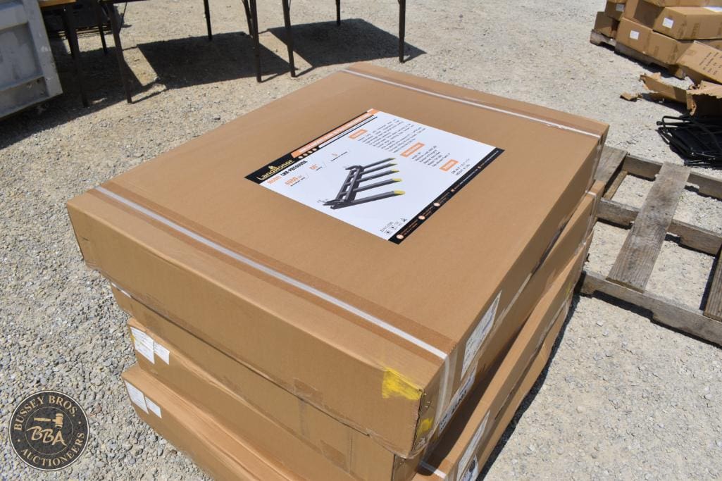 Large cardboard boxes containing outdoor fire pit kits for sale at auction.