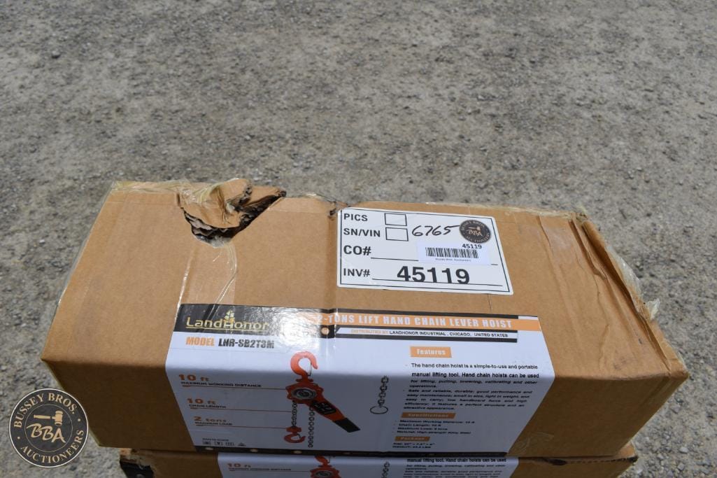 Auction lot of landscaping equipment with chains and hooks.