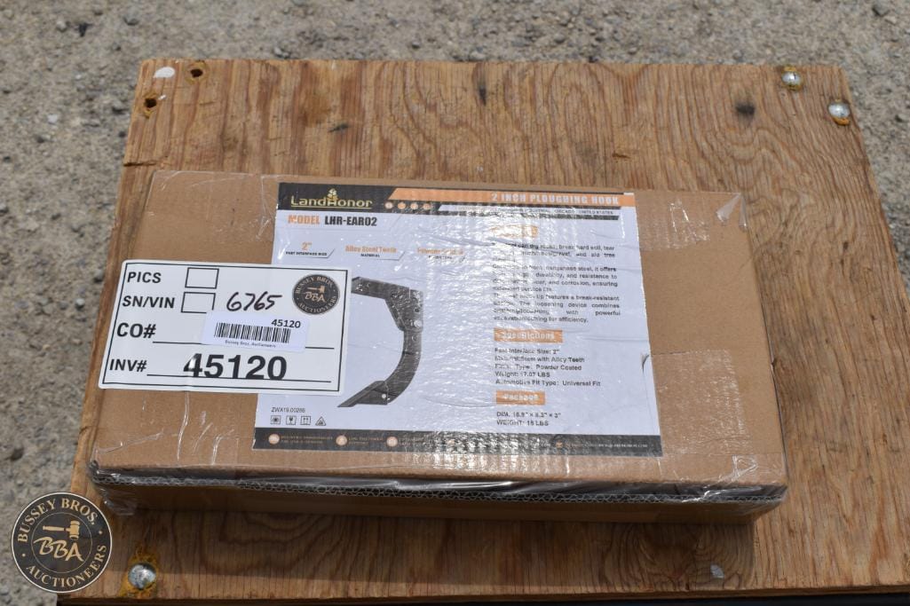 Box of industrial equipment with shipping label on wooden surface.