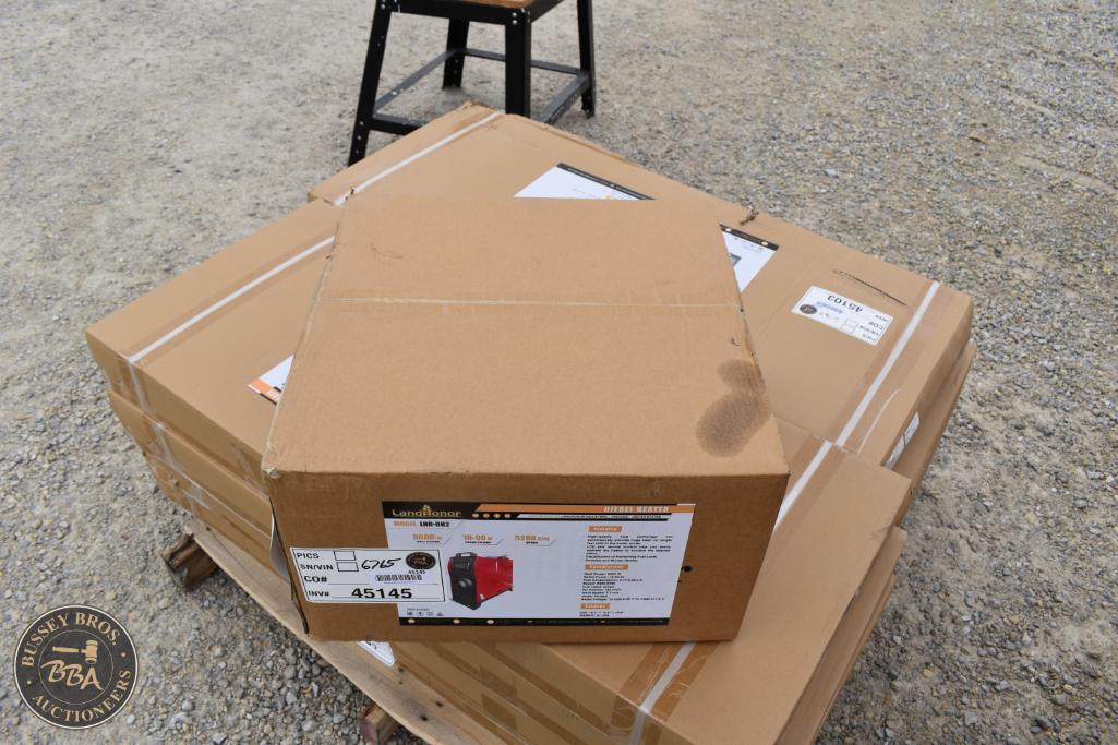 New lawn mower in packaging box on pallet at Bussey Bros Auctioneers.