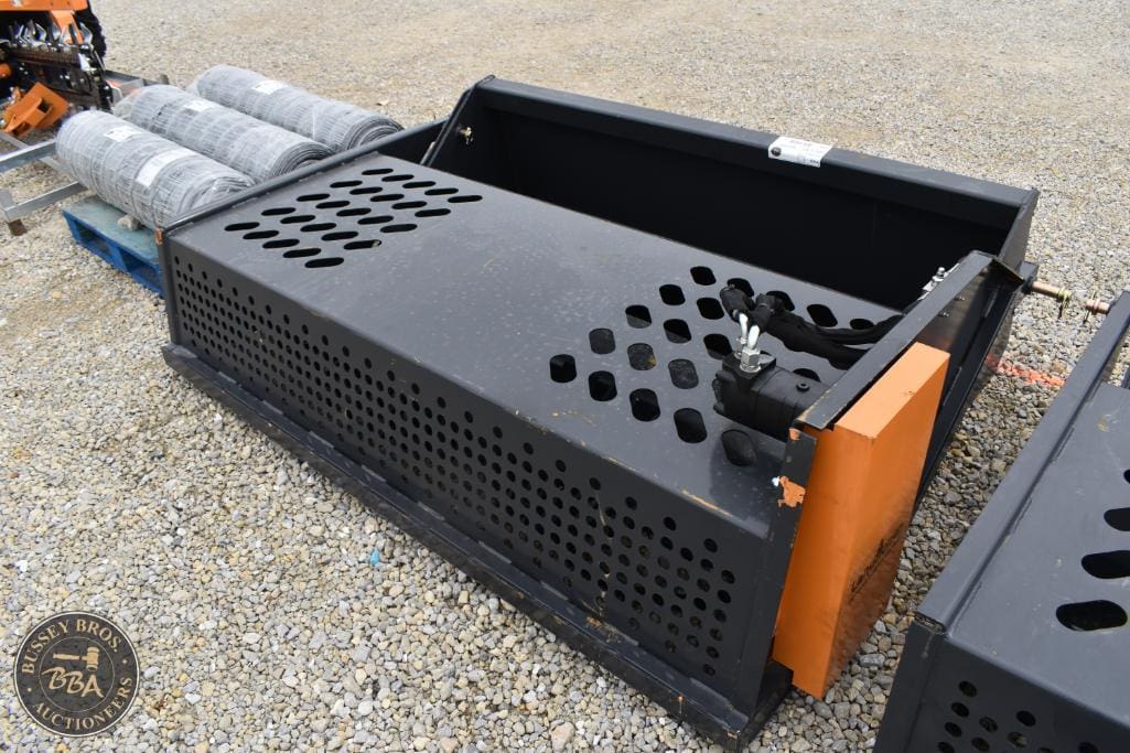 Heavy machinery attachment for construction equipment, black perforated metal with orange accents.