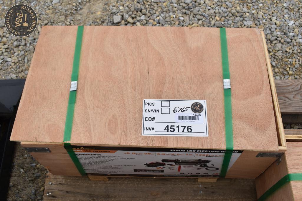 Wooden shipping crate secured with green straps, ready for auction.