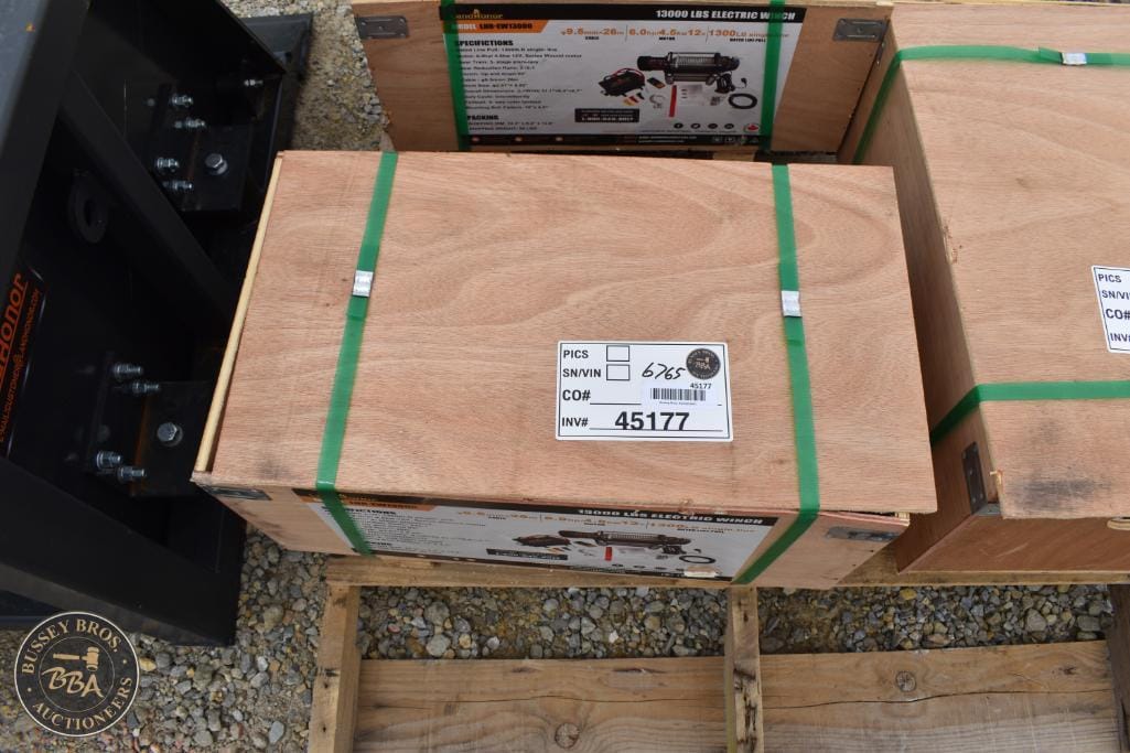 Wooden crate with green straps, ready for auction at Bussey Bros Auctioneers.