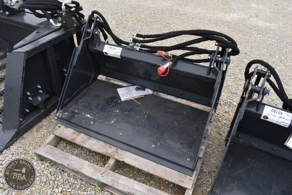 Excavator bucket attachment with hydraulic hoses, suitable for construction equipment.