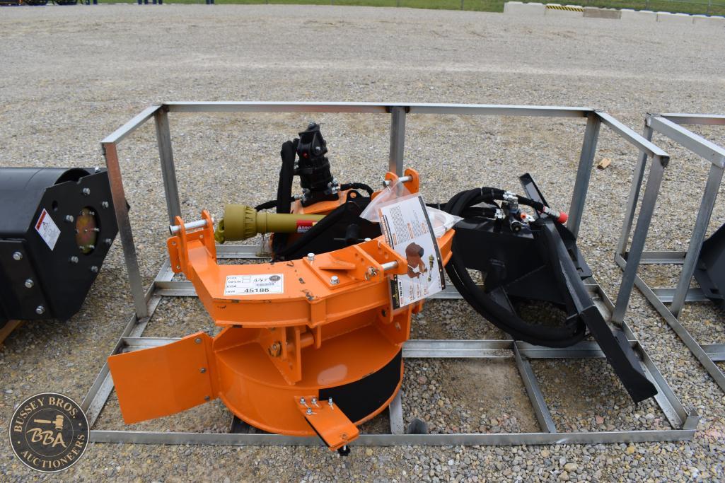 Heavy machinery attachment for construction or industrial use, displayed outdoors on gravel.