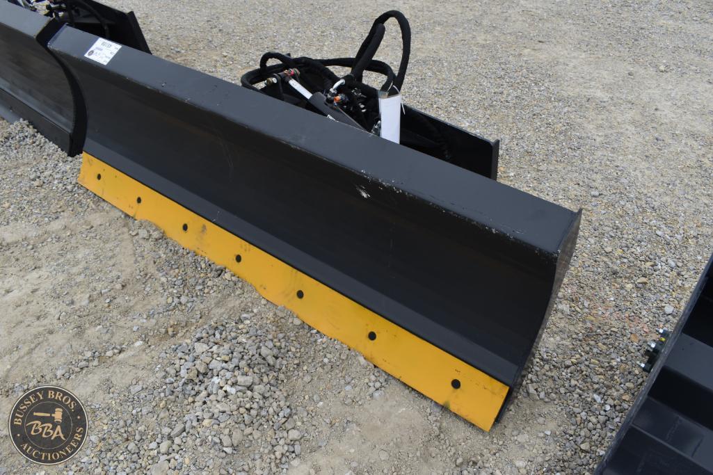 Heavy-duty black and yellow snow plow attachment for tractors at Bussey Bros Auctioneers.