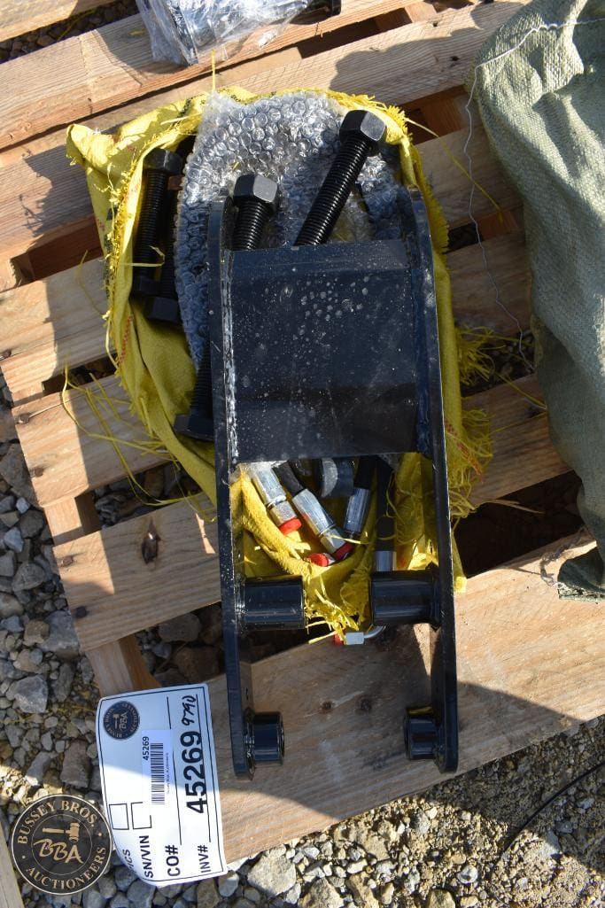 Equipment auction lot with tools and gear on a wooden pallet.