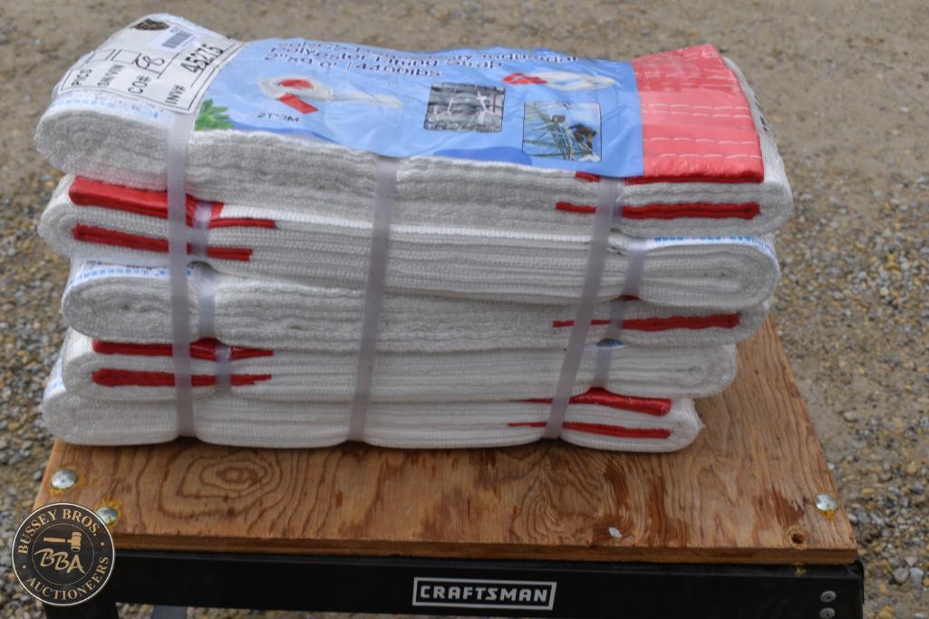 Durable white and red towels stacked on a wooden table, ready for bidding.