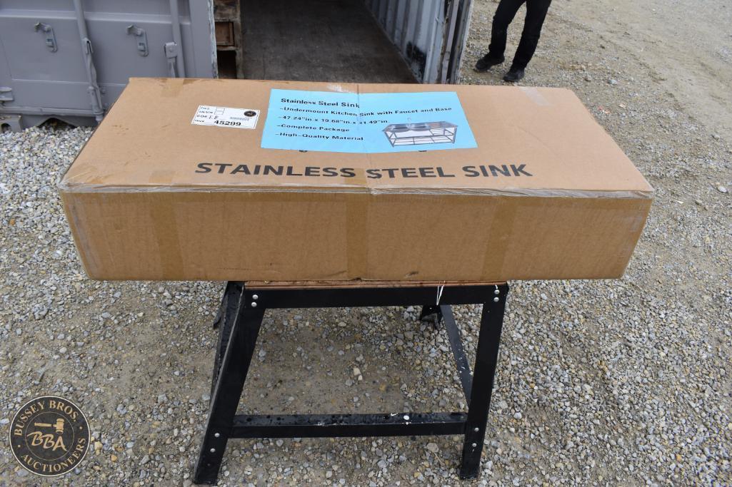 New stainless steel sink in packaging on display at Bussey Bros Auctioneers.