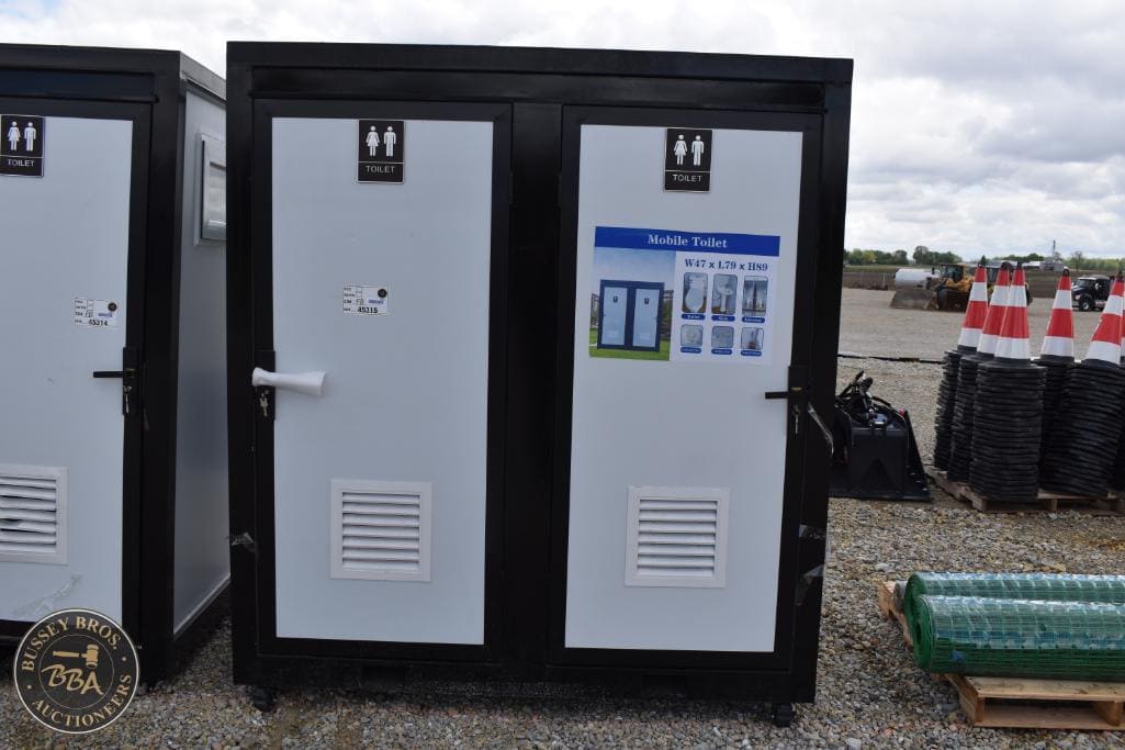 Portable toilet unit at Bussey Bros Auctioneers outdoor event site.