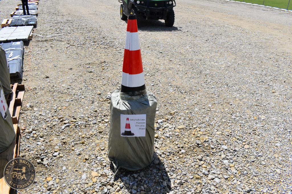 Traffic cone with safety base at outdoor auction site.