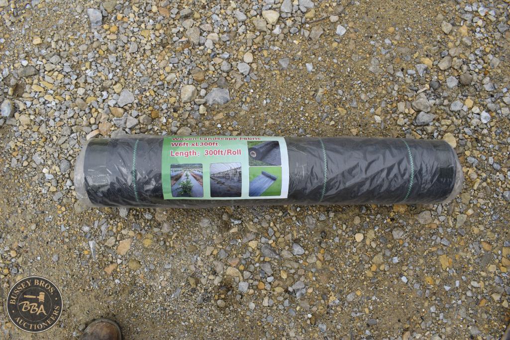 Black plastic ground sheet roll for outdoor protection and landscaping.