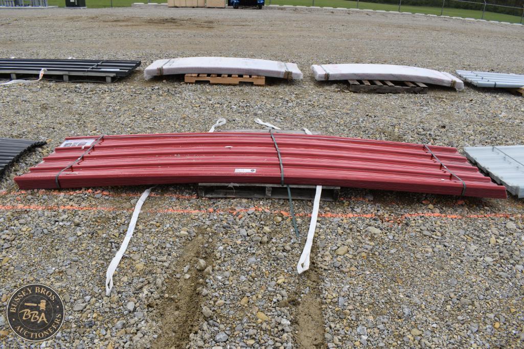 Red boat hulls, boat parts, and marine equipment at auction.