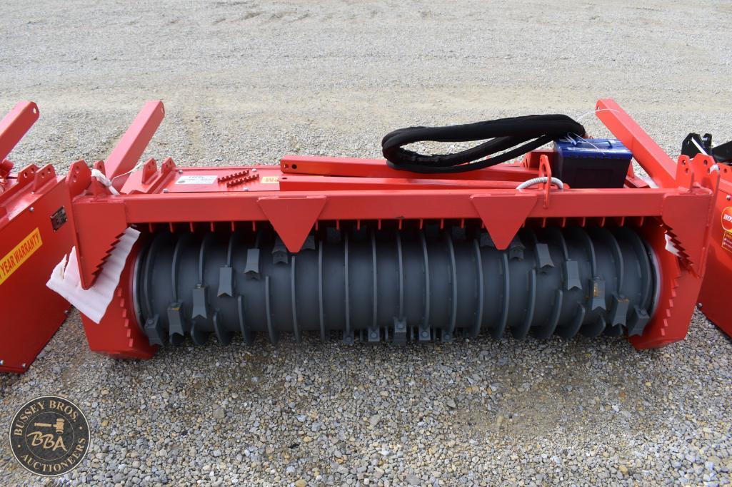 Agricultural roller for soil preparation, red machinery at a farm auction.