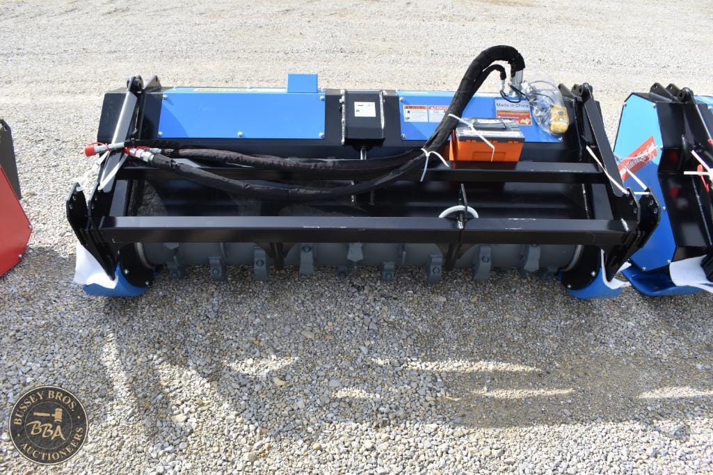 Mulcher attachment for tractors used in land clearing and vegetation management.