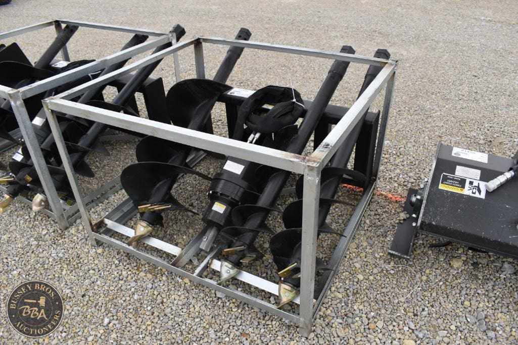 Farm equipment shovels and attachments displayed in a metal cage at Bussey Bros Auctioneers.