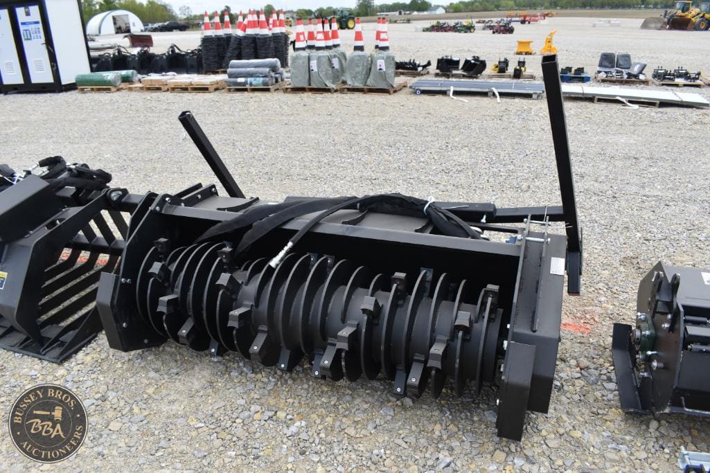 Farm machinery and attachments for sale at Bussey Bros Auctioneers, including tillers, plows, and cu.