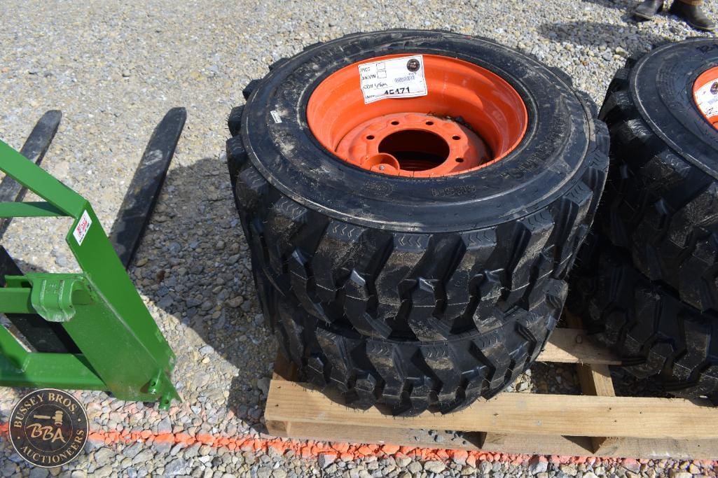 Farm tractor tire with orange rim for agricultural machinery.