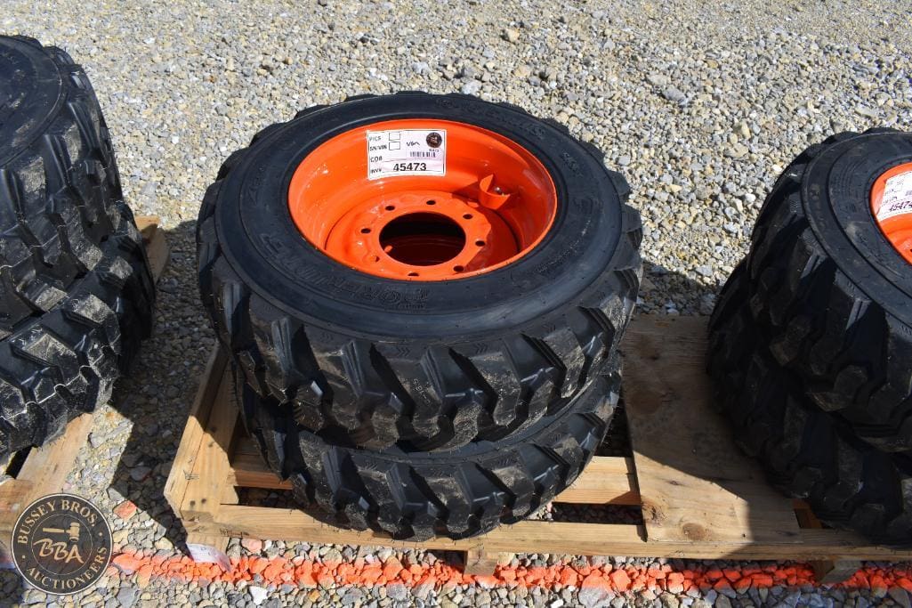 Farm tractor tires with bright orange rims for agricultural machinery.