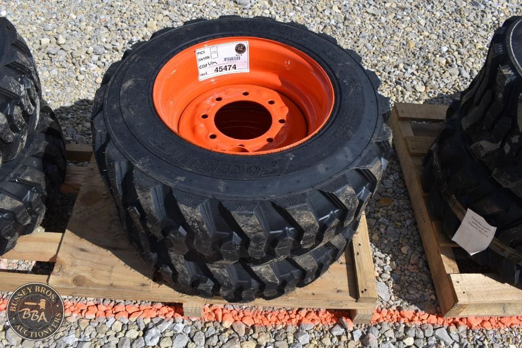 Farm tractor tire with orange rim for sale at Bussey Bros Auctioneers.