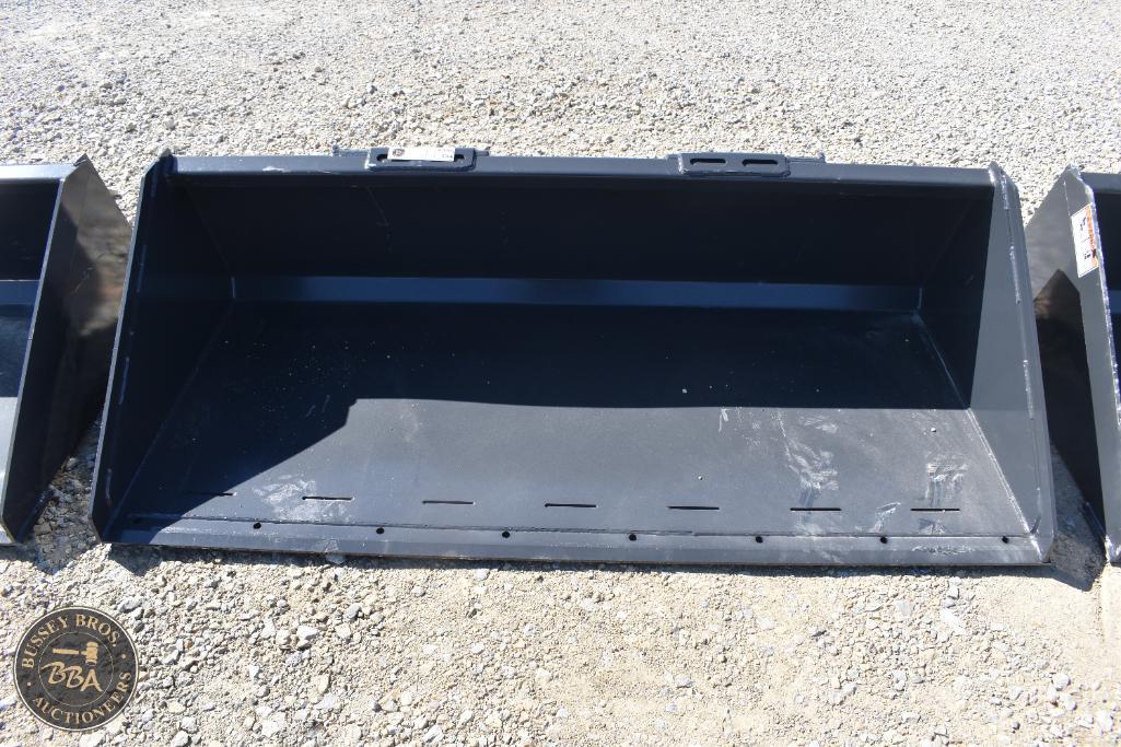 Heavy-duty black farm equipment bucket for agricultural use.