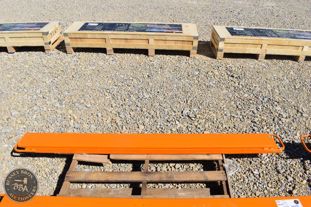 Orange rescue spine board on wooden pallet at a heavy equipment auction.