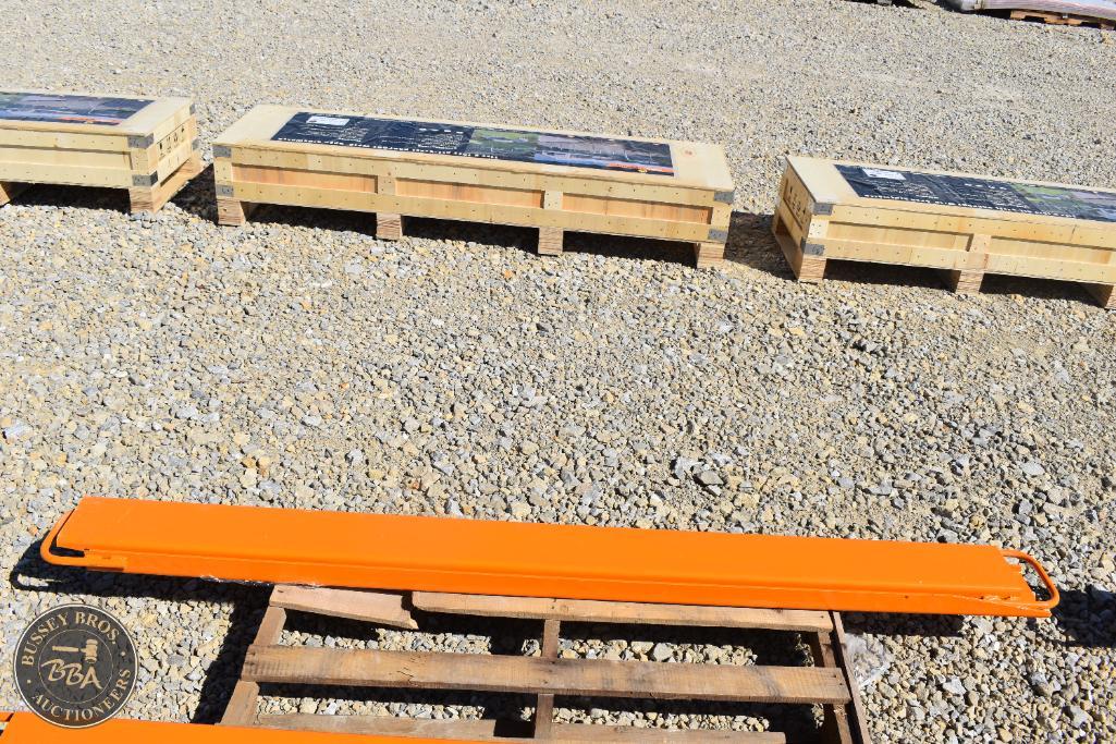 Orange safety barrier on wooden pallet at Bussey Bros Auctioneers outdoor sale.