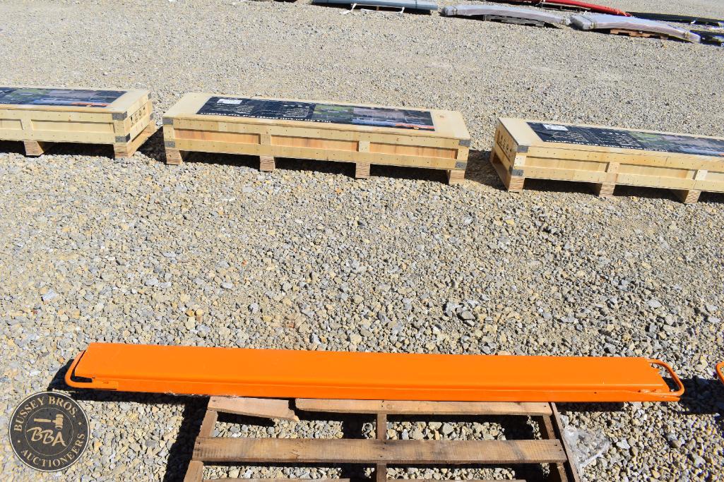Outdoor equipment including a bright orange safety barrier on a wooden pallet at a Bussey Bros aucti.