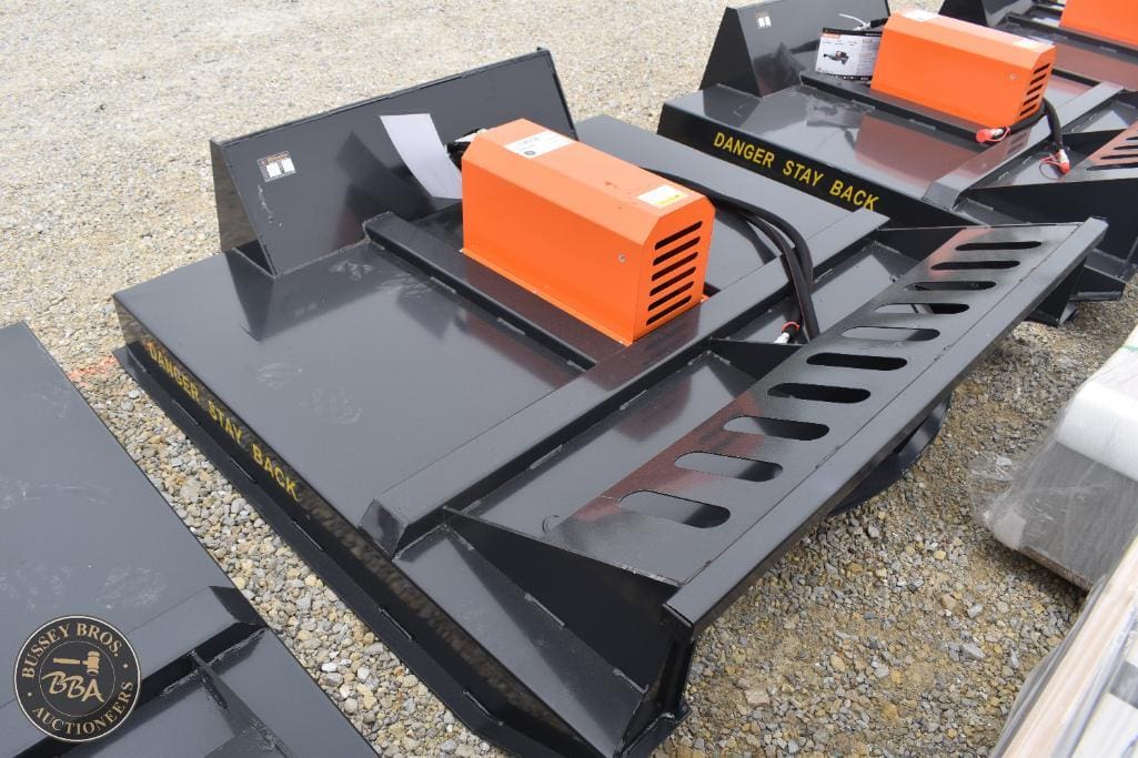 Heavy-duty skid steer attachment with orange hydraulic component for construction use.
