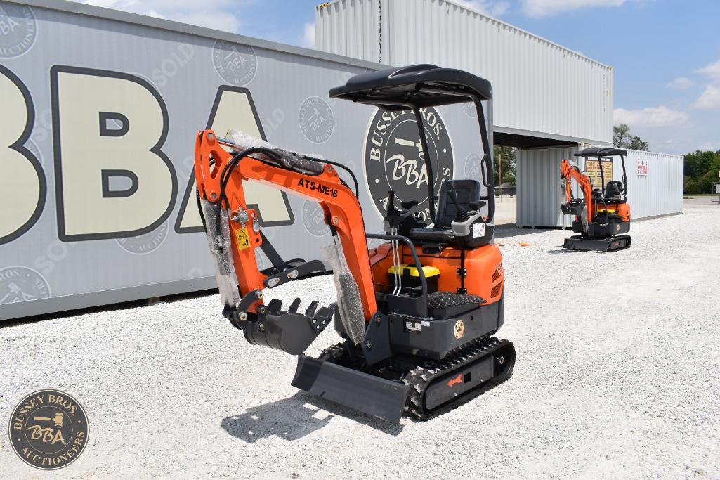 Compact orange mini excavator with black tracks at Bussey Bros Auctioneers yard.