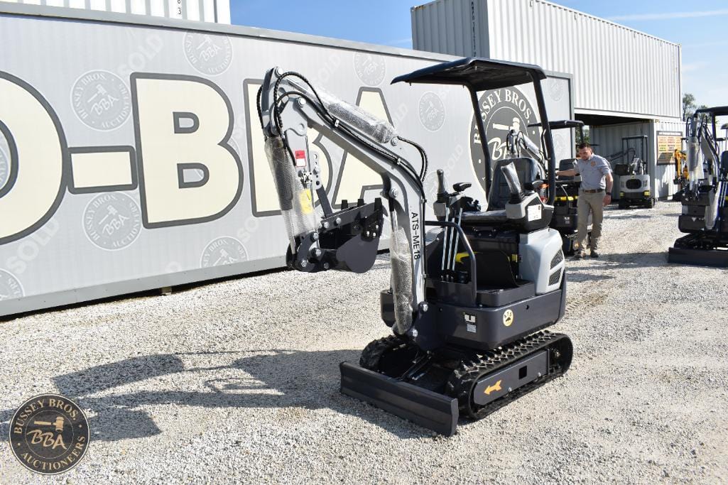 Compact mini excavator with hydraulic arm and tracked undercarriage for construction and landscaping.
