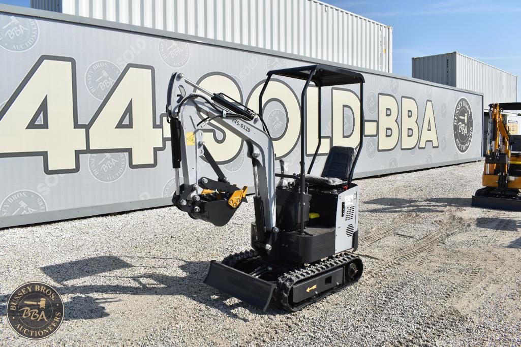 Mini excavator with compact design and hydraulic arm, available at Bussey Bros Auctioneers. Perfect.