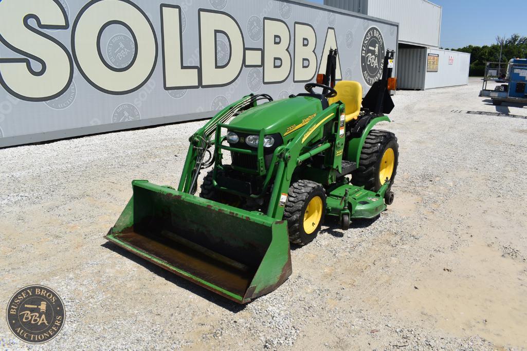 Compact green tractor with front loader attachment, ideal for farming and landscaping projects.