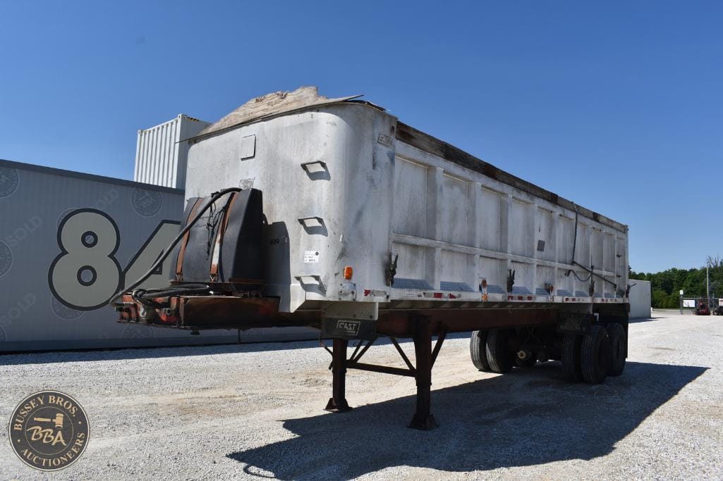 Old white dump trailer at Bussey Bros Auctioneers yard, ready for sale.