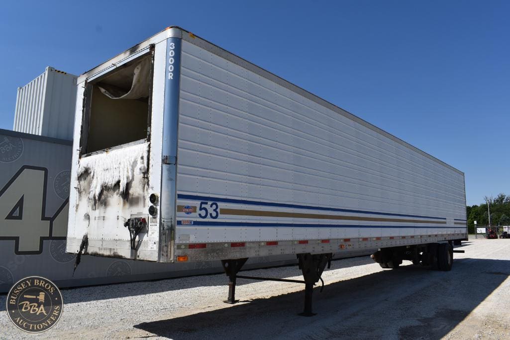 Large white semi-trailer with damage at the front, available for auction at Bussey Bros Auctioneers.
