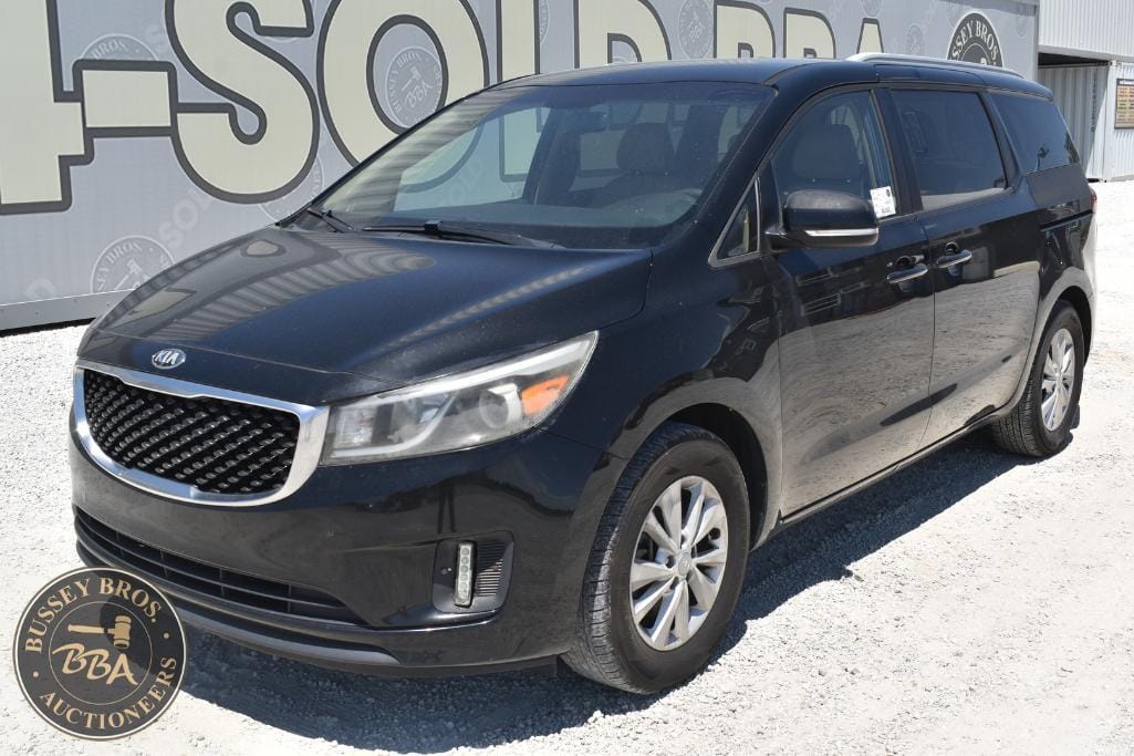 Black Kia Sedona minivan showcased at Bussey Bros Auction, ready for sale or bidding.
